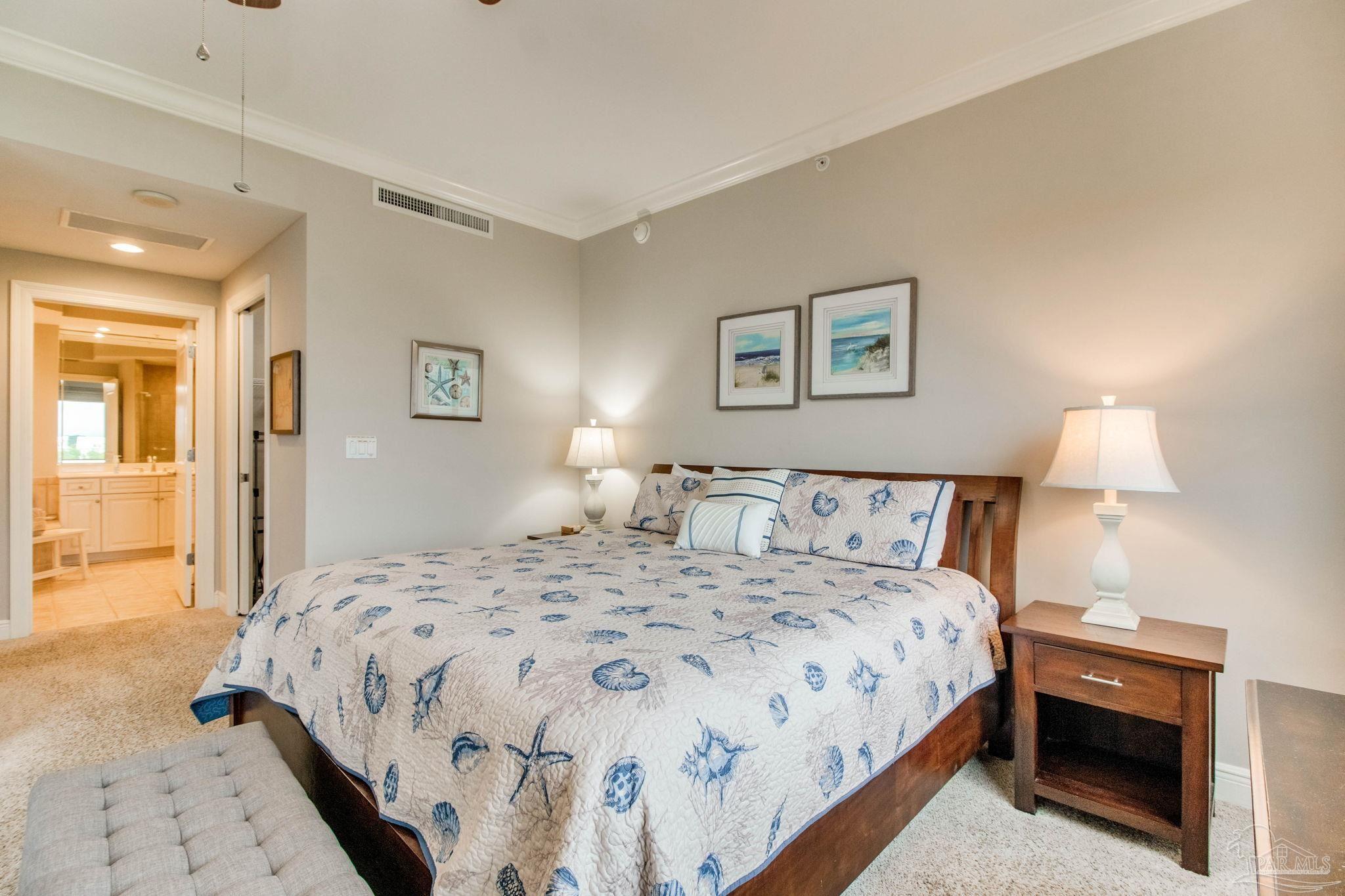 612 Lost Key Drive, Unit 405B Pensacola, FL 32507 - Photo 25 of 71 a bedroom with a bed and a lamp