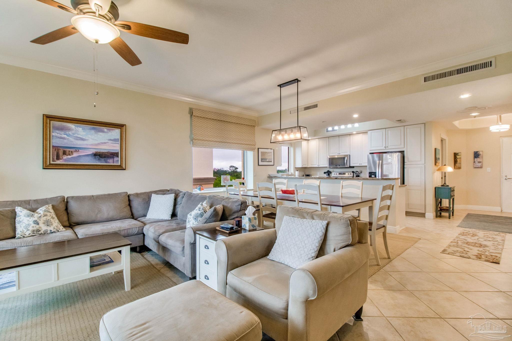 612 Lost Key Drive, Unit 405B Pensacola, FL 32507 - Photo 28 of 71 a living room with furniture kitchen view and a chandelier