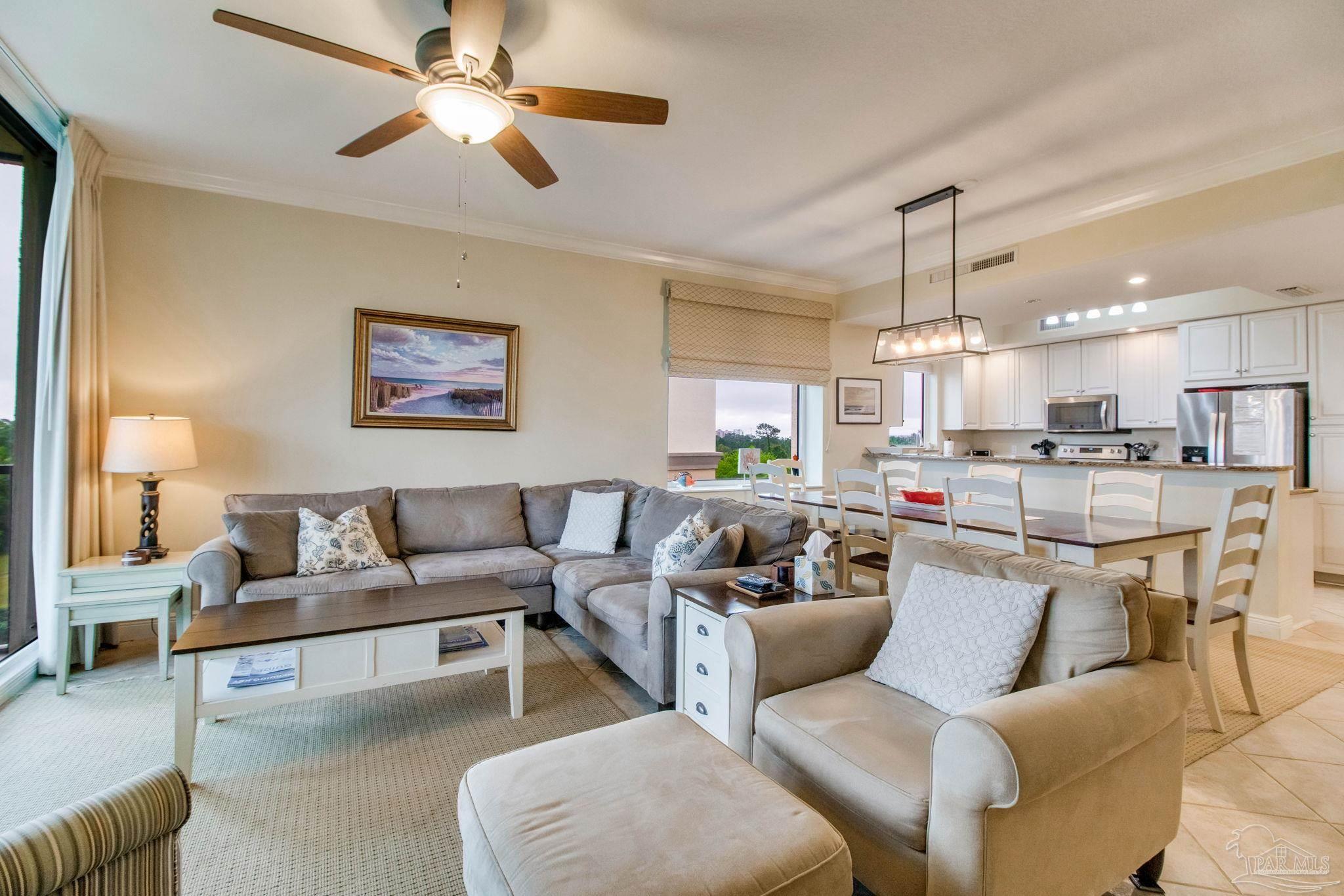 612 Lost Key Drive, Unit 405B Pensacola, FL 32507 - Photo 29 of 71 a living room with furniture kitchen view and a chandelier