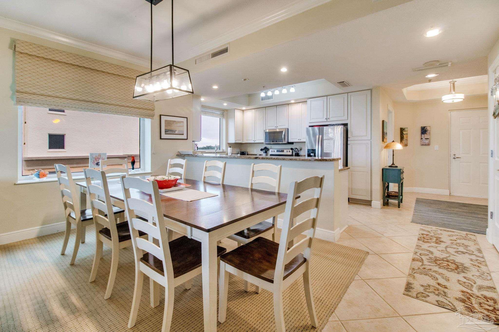 612 Lost Key Drive, Unit 405B Pensacola, FL 32507 - Photo 32 of 71 a large kitchen with a table and chairs