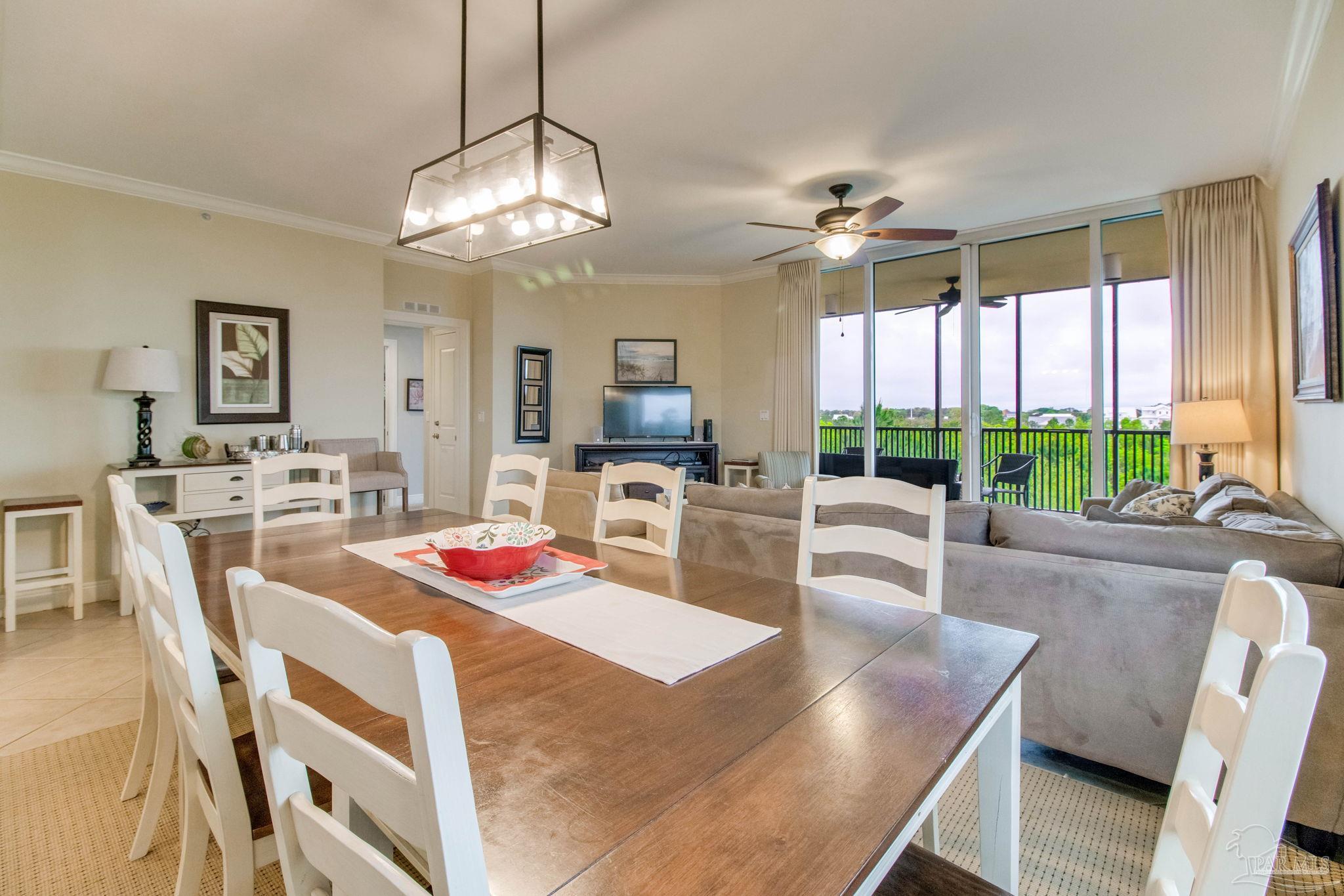 612 Lost Key Drive, Unit 405B Pensacola, FL 32507 - Photo 34 of 71 a dining room with furniture a chandelier and wooden floor