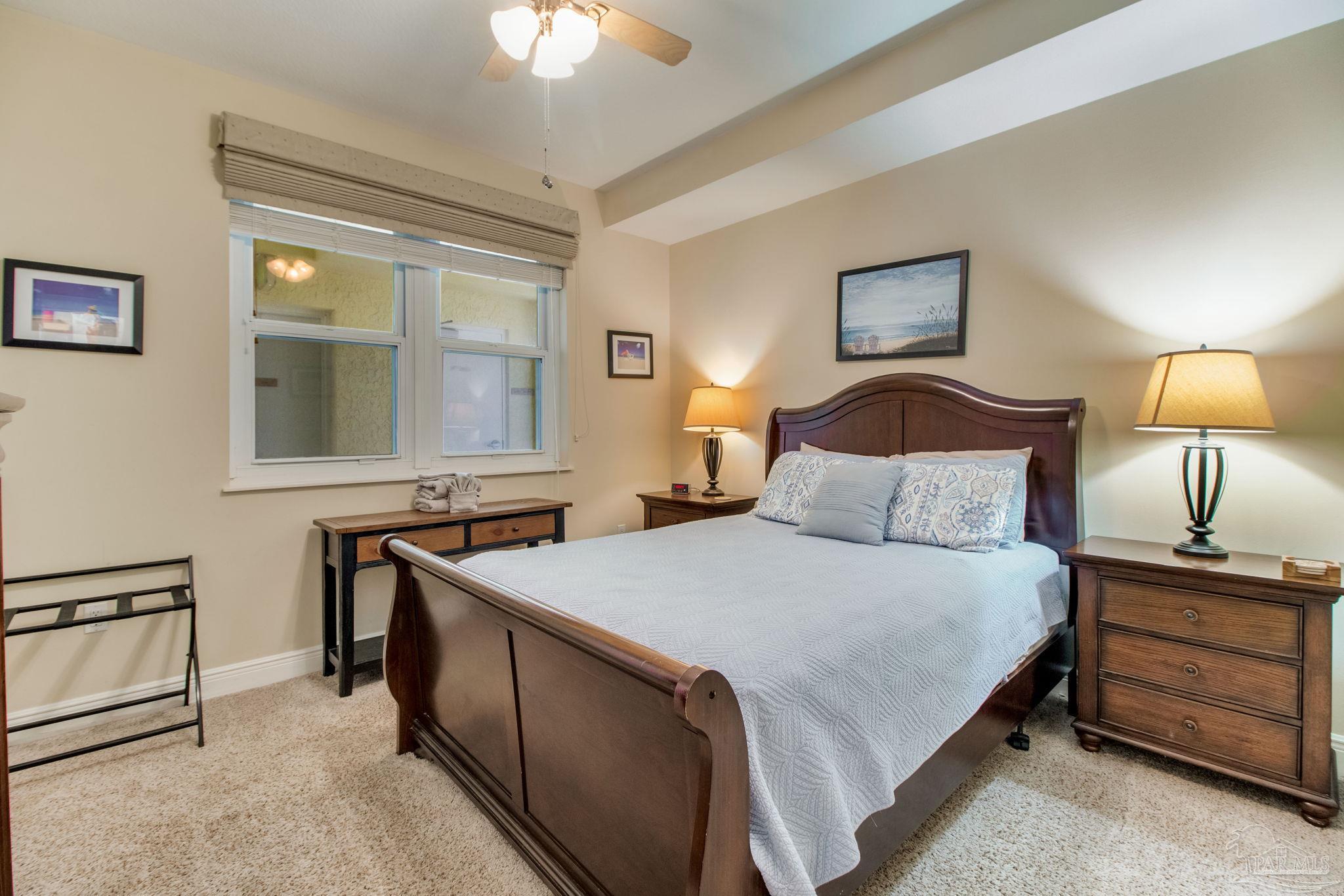 612 Lost Key Drive, Unit 405B Pensacola, FL 32507 - Photo 37 of 71 a bedroom with a bed and a lamp on dresser