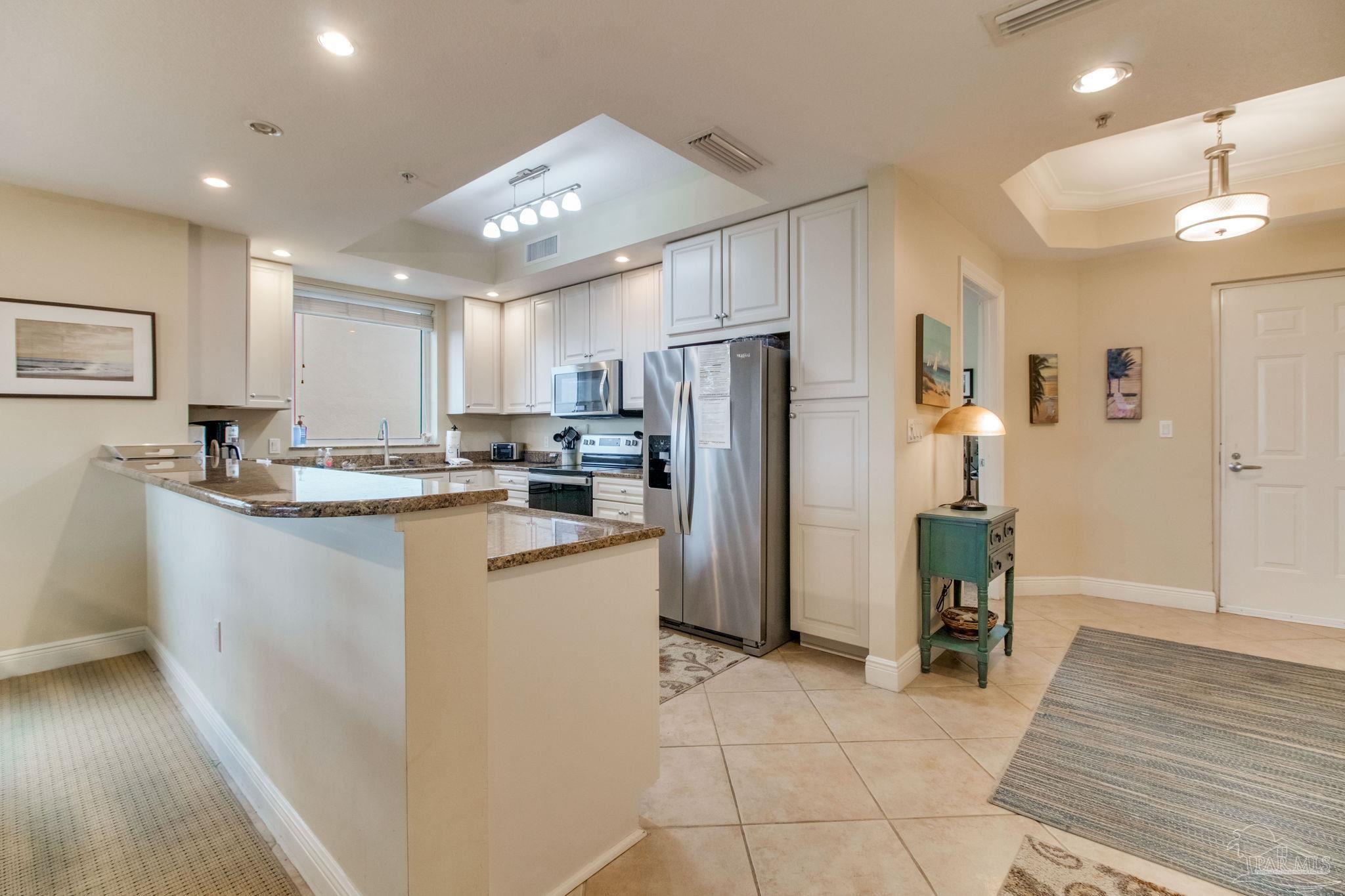 612 Lost Key Drive, Unit 405B Pensacola, FL 32507 - Photo 38 of 71 a kitchen with refrigerator and cabinets