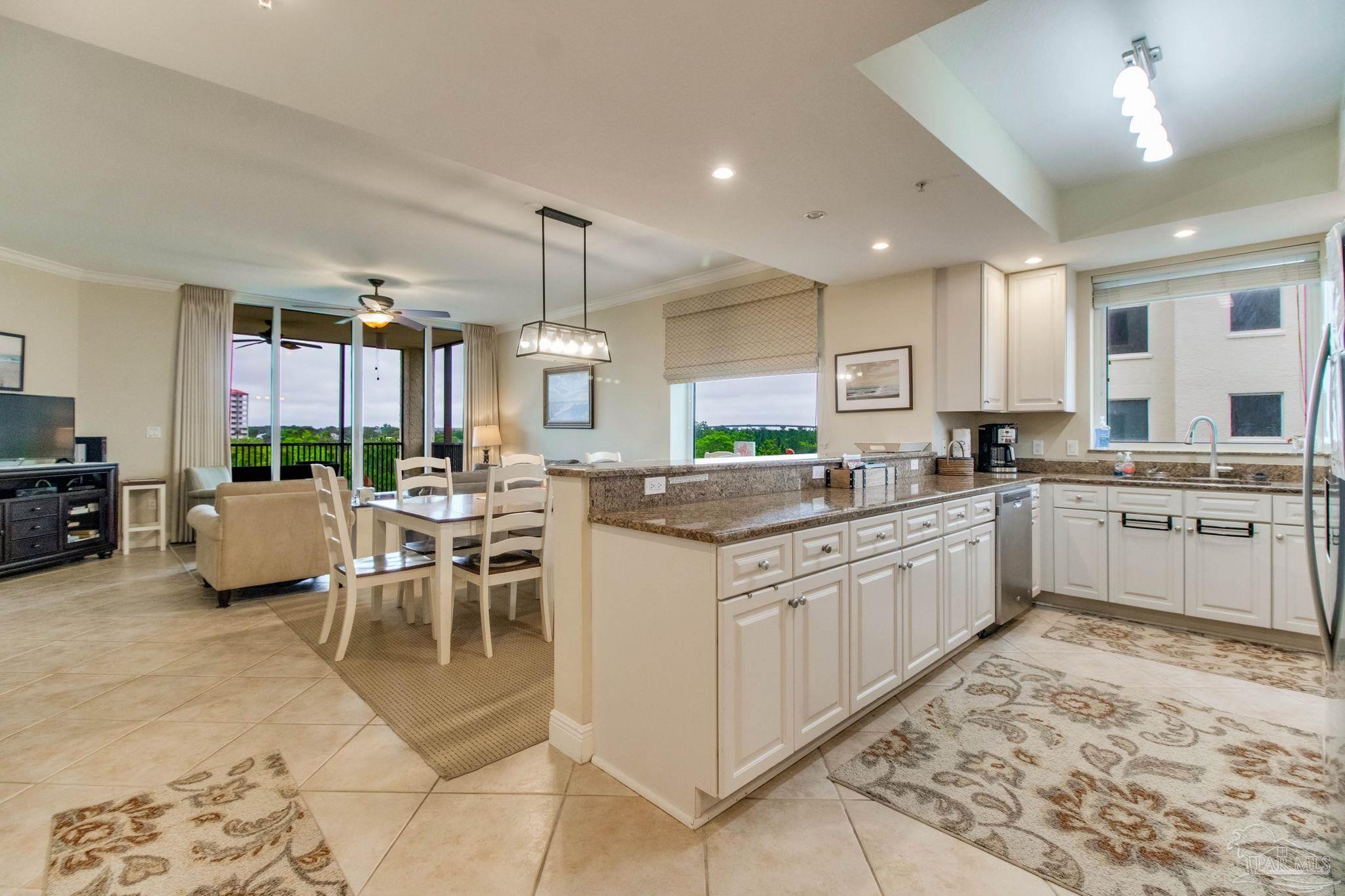 612 Lost Key Drive, Unit 405B Pensacola, FL 32507 - Photo 40 of 71 a kitchen with stainless steel appliances kitchen island granite countertop a sink and cabinets