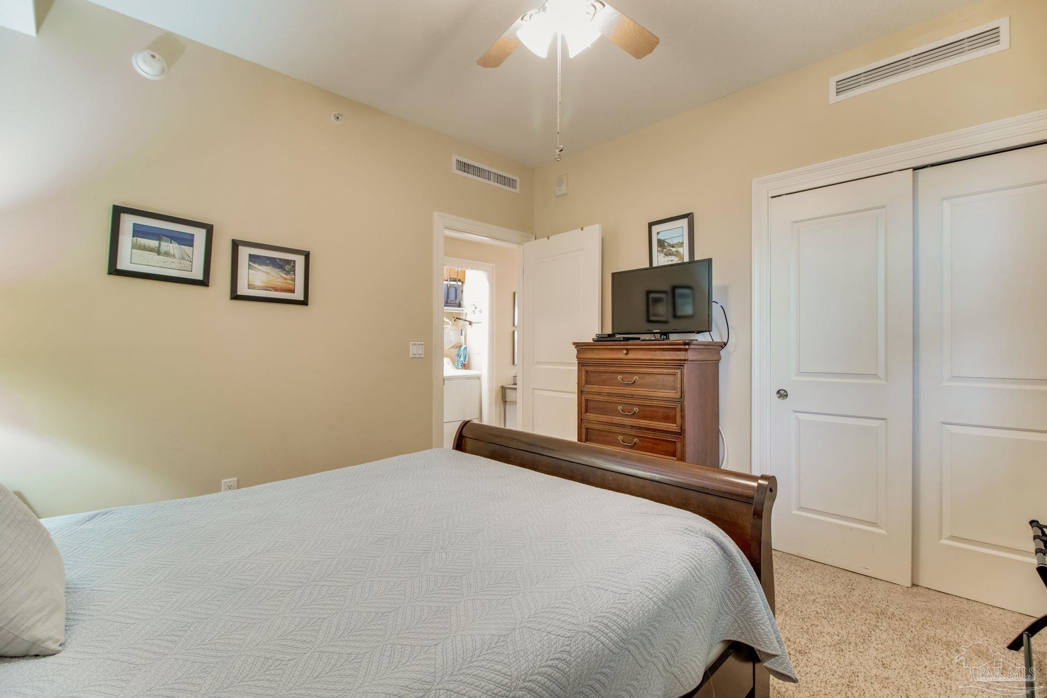612 Lost Key Drive, Unit 405B Pensacola, FL 32507 - Photo 43 of 71 a bedroom with a bed and a television