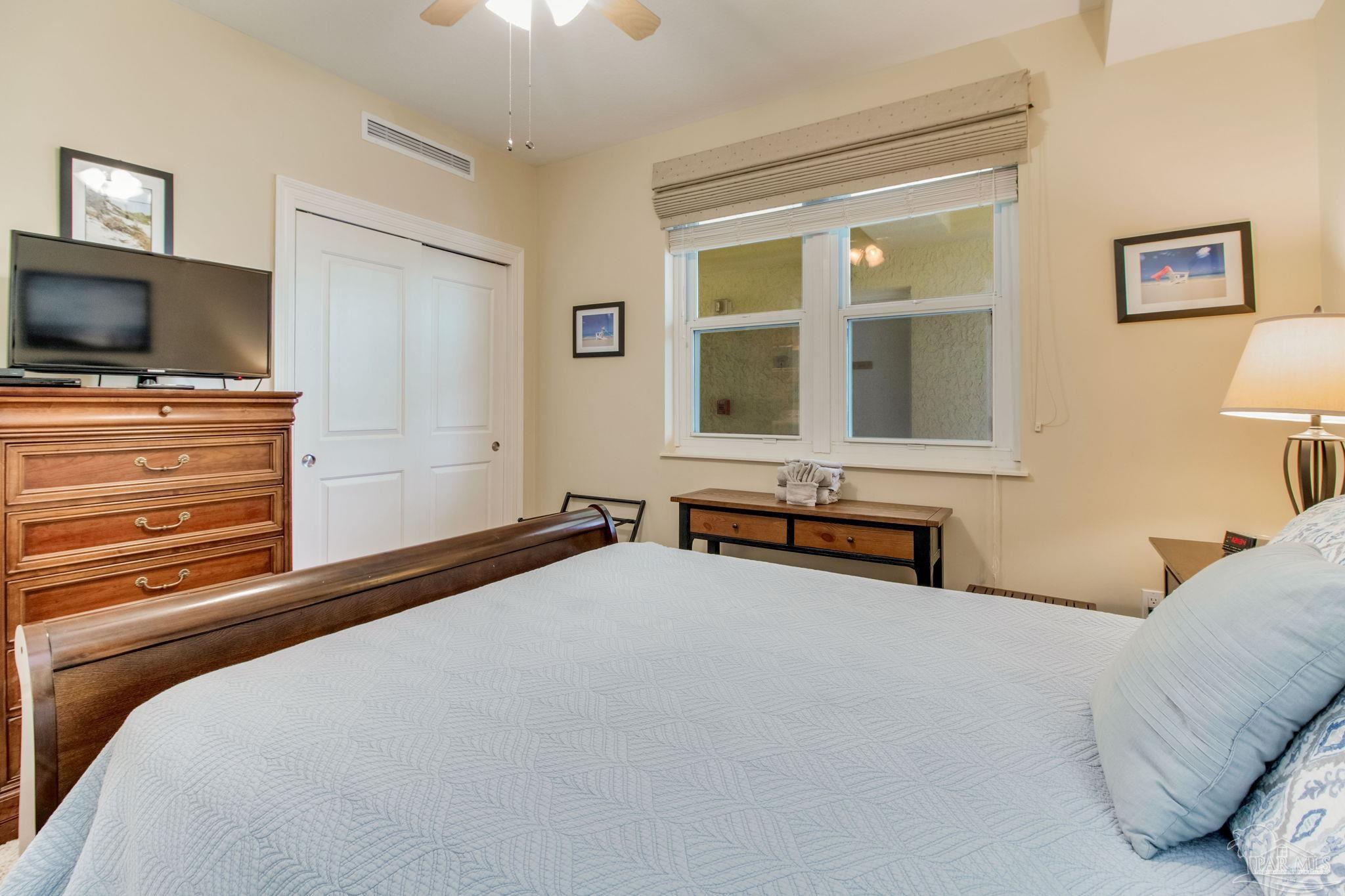 612 Lost Key Drive, Unit 405B Pensacola, FL 32507 - Photo 45 of 71 a bedroom with a bed and a flat screen tv