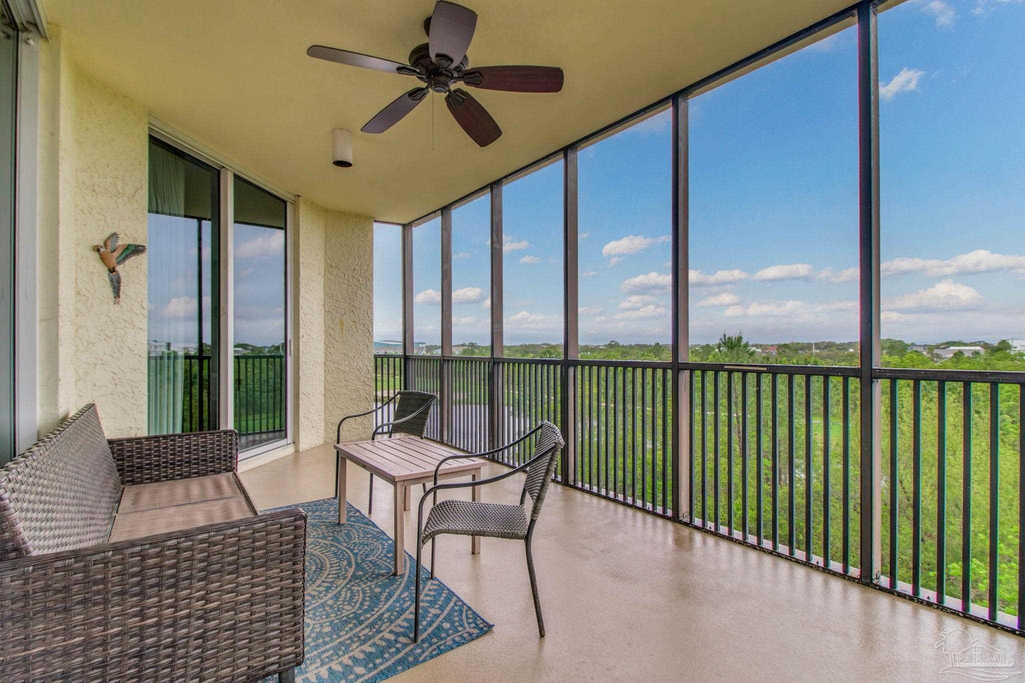 612 Lost Key Drive, Unit 405B Pensacola, FL 32507 - Photo 49 of 71 a living room with furniture and a floor to ceiling window