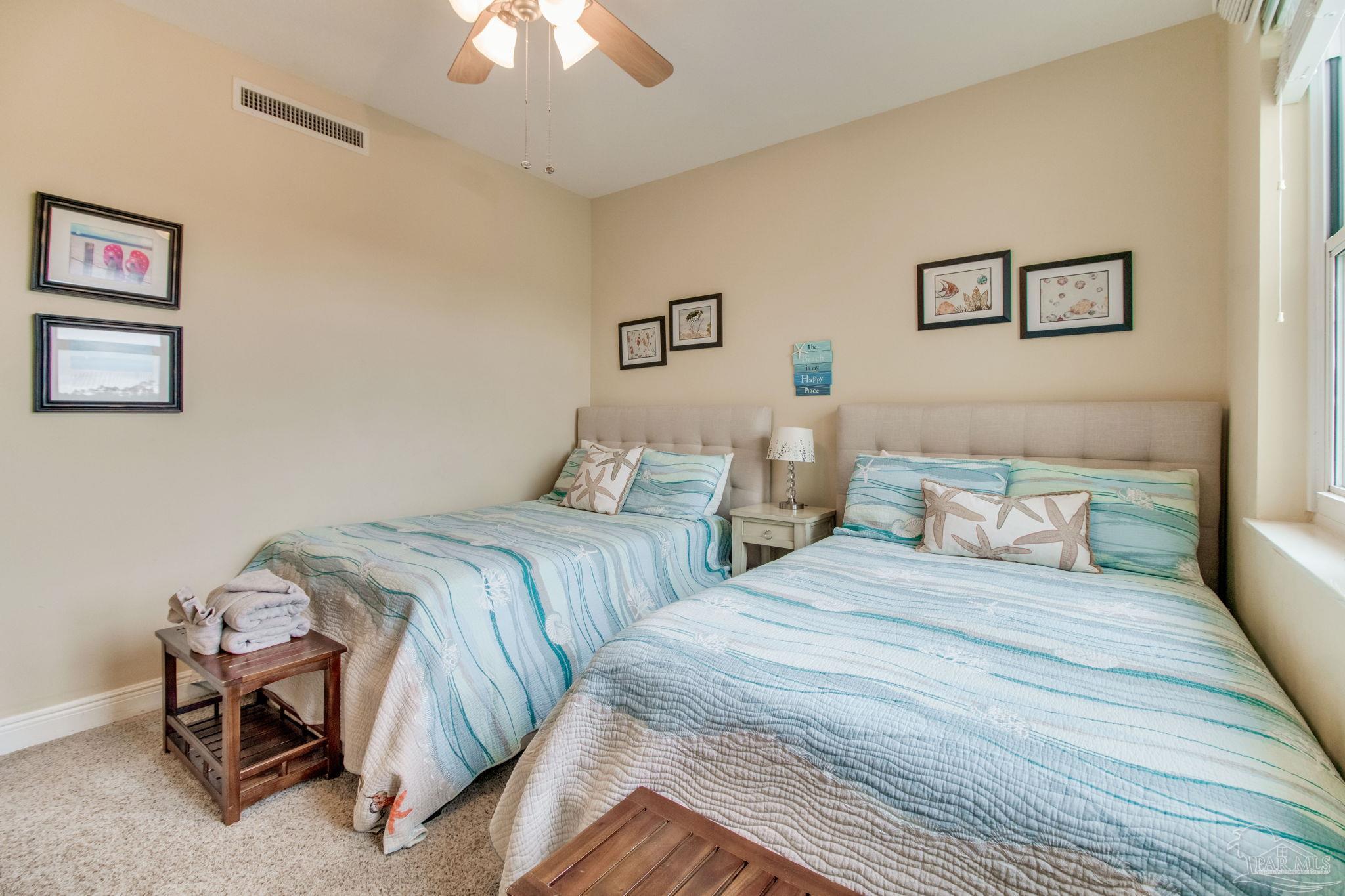 612 Lost Key Drive, Unit 405B Pensacola, FL 32507 - Photo 5 of 71 a bedroom with double bed and a chandelier