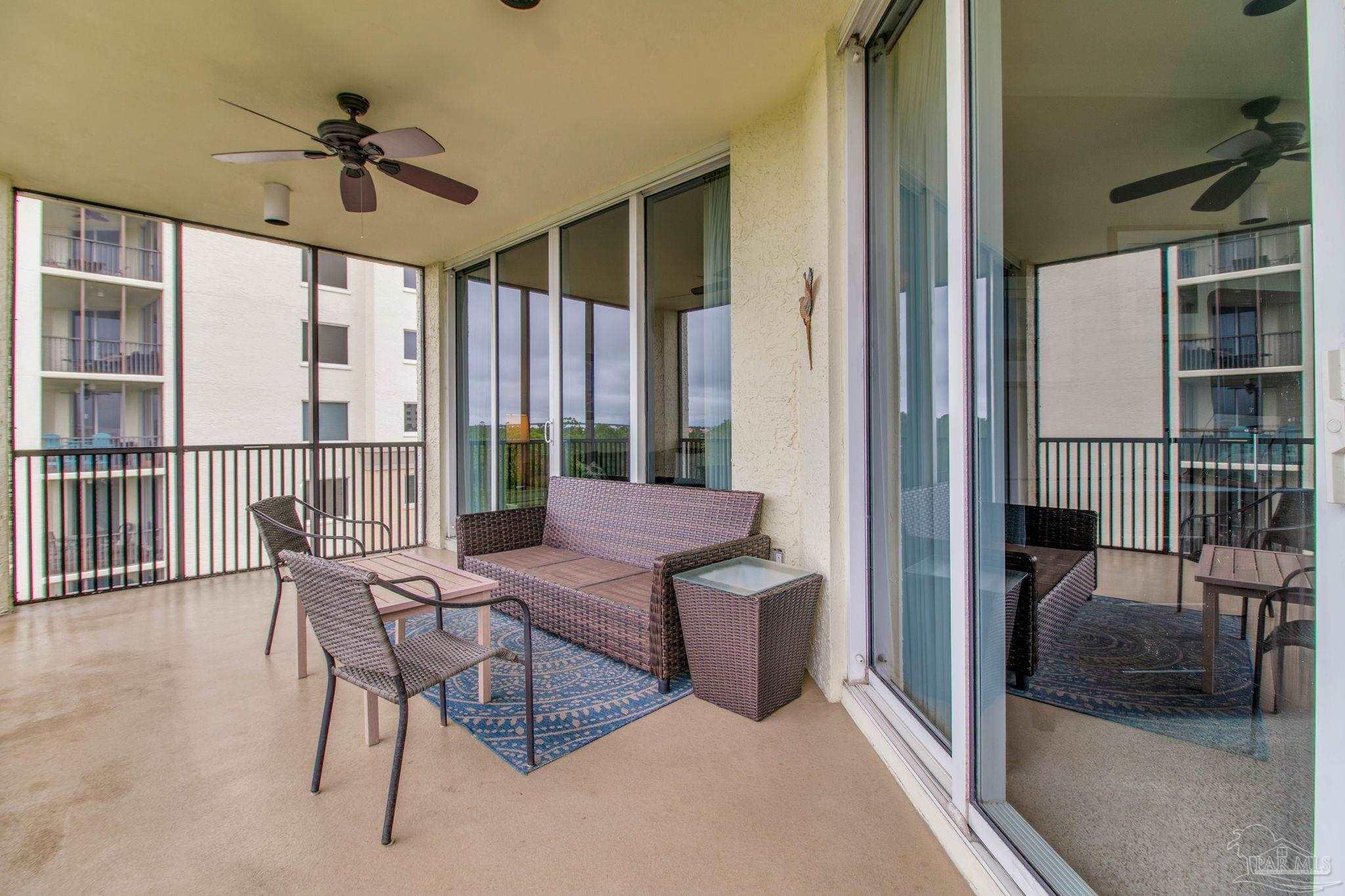 612 Lost Key Drive, Unit 405B Pensacola, FL 32507 - Photo 51 of 71 a view of a livingroom with furniture and a floor to ceiling window