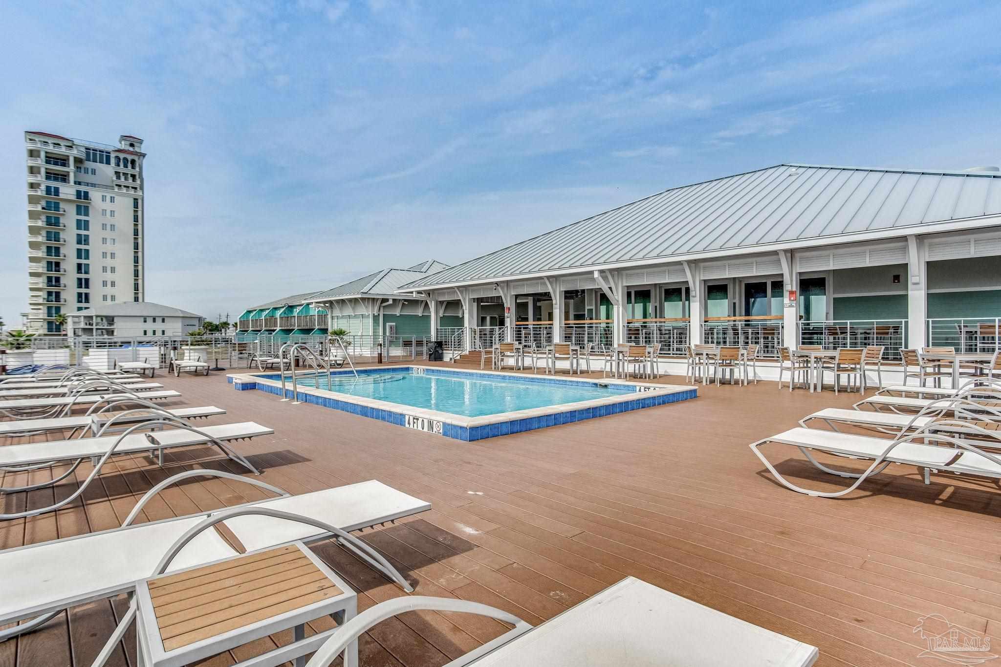 612 Lost Key Drive, Unit 405B Pensacola, FL 32507 - Photo 60 of 71 a view of a patio with swimming pool table and chairs