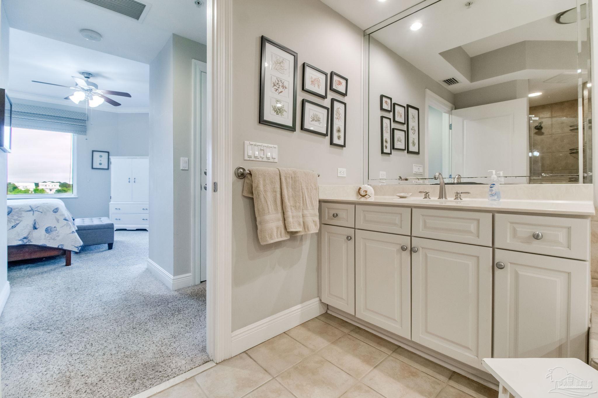 612 Lost Key Drive, Unit 405B Pensacola, FL 32507 - Photo 6 of 71 a en suite bathroom with a double vanity sink and a mirror