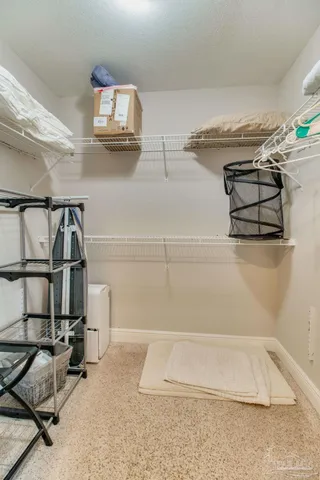 a view of a hallway with wooden floor and a living room