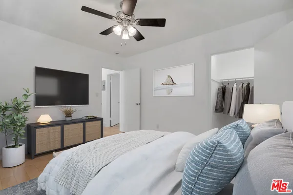 a bedroom with a bed and a flat screen tv