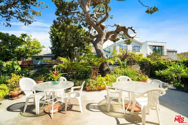 a view of a chairs and table in a patio