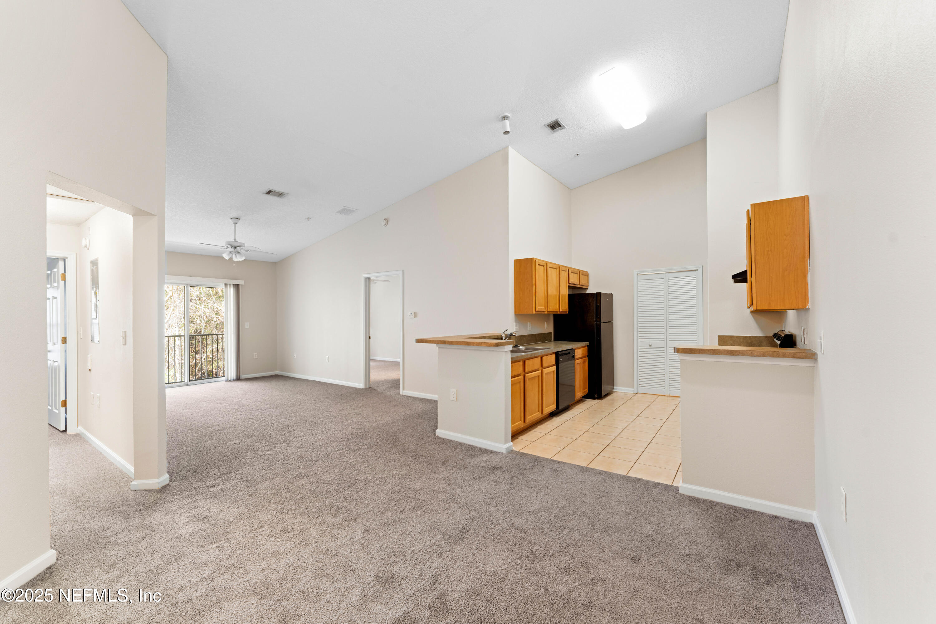 7920 Merrill Road, Unit 1712 Jacksonville, FL 32277 - Photo 5 of 23 a view of a kitchen with furniture and stainless steel appliances