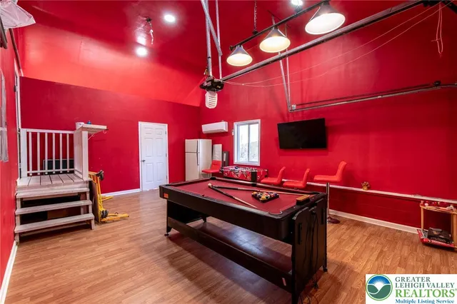a view of a room with chairs and wooden floor