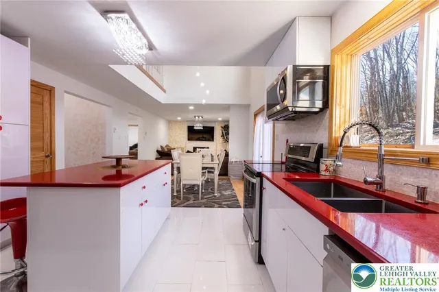 a kitchen filled counter top space a sink cabinets and appliances