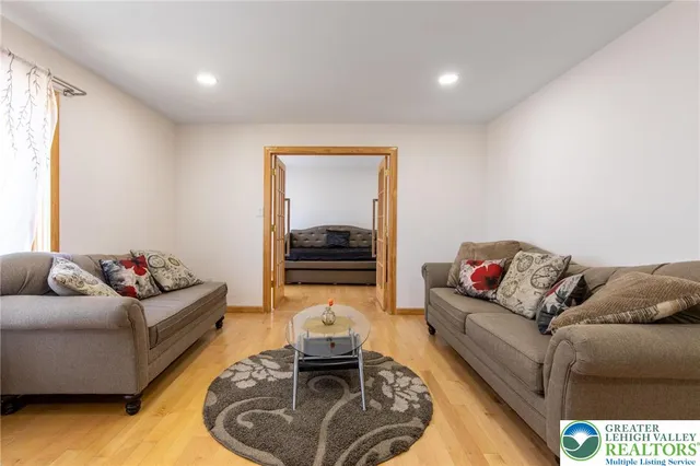 a living room with furniture and a wooden floor