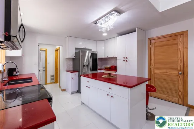 a kitchen with stainless steel appliances a sink cabinets and wooden floor