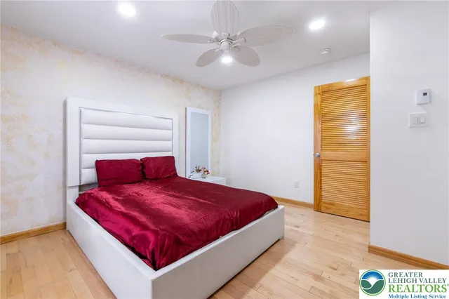 a bedroom with a bed and a chandelier