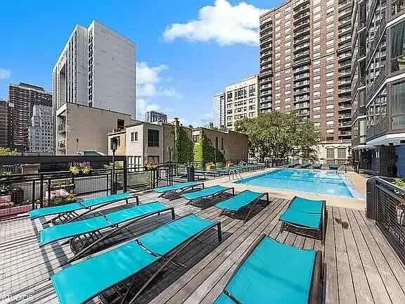 a view of a balcony with chairs and wooden floor