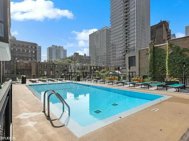 a swimming pool with outdoor seating and yard