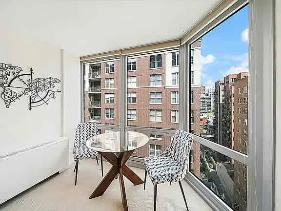 a view of a balcony dining table and chairs