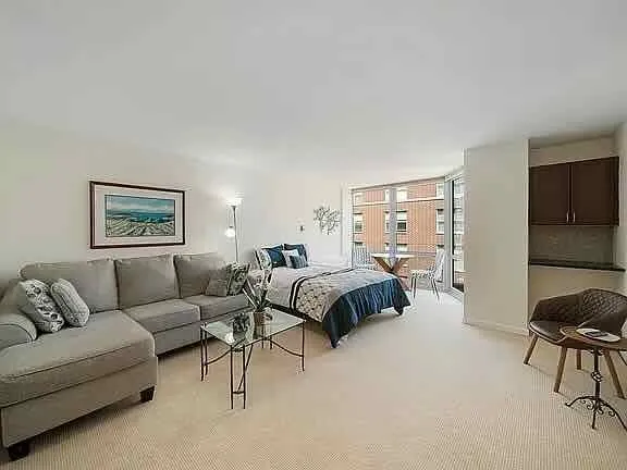 a bedroom with a bed and a couch