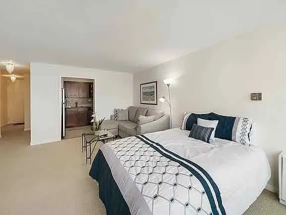 a bedroom with a bed and a lamp