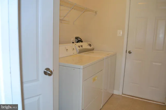 a utility room with a sink dryer and washer