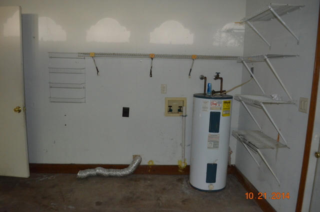 166 Ridge Lake Road Crestview, FL 32536 - Photo 7 of 19 a view of storage and utility room with water heater and racks on the wall