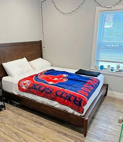 a bedroom with a bed and window