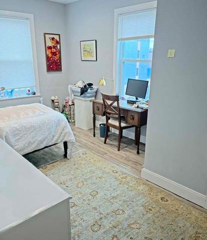 a room with a bed and a table in it