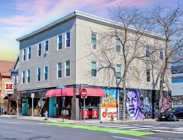 a man walking down a street next to a building