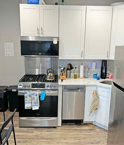 a kitchen with a stove a sink and a microwave