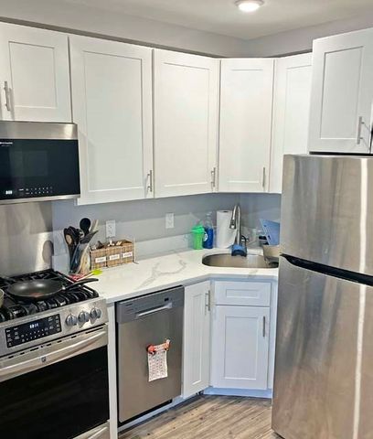 a kitchen with a stove a sink and a refrigerator