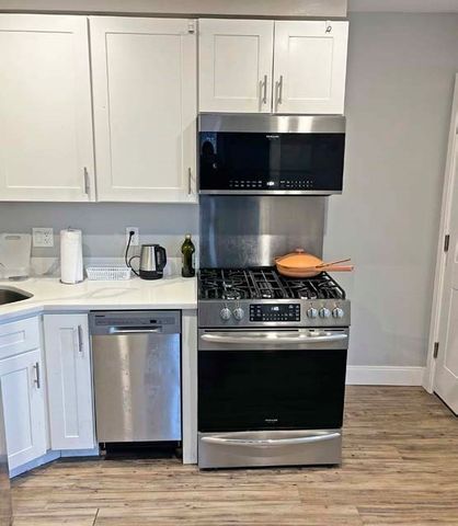 a stove top oven sitting inside of a kitchen