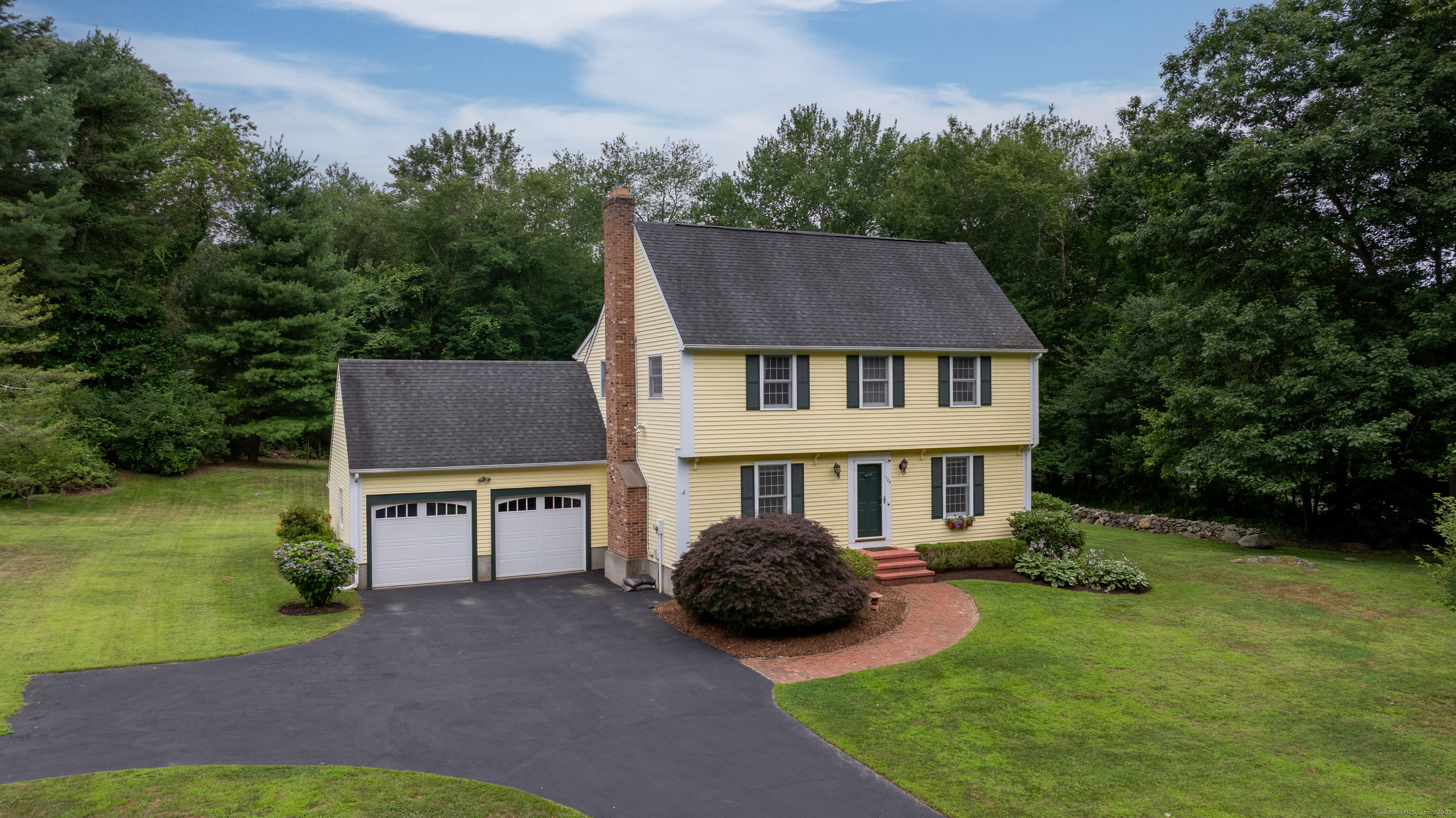 a aerial view of a house with swimming pool garden and patio