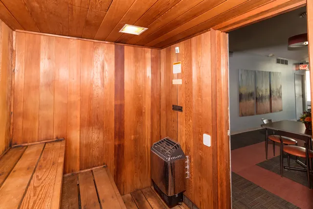 a room with stainless steel appliances kitchen island granite countertop furniture and a large window