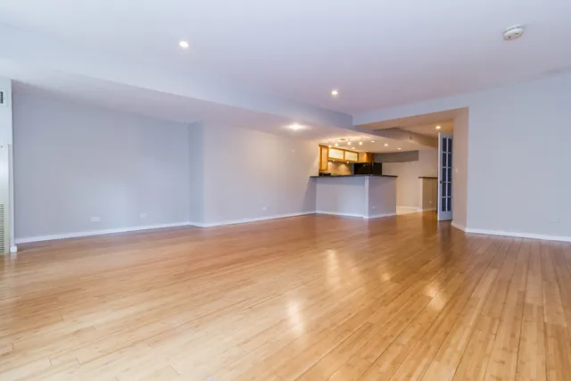 a view of a room with wooden floor