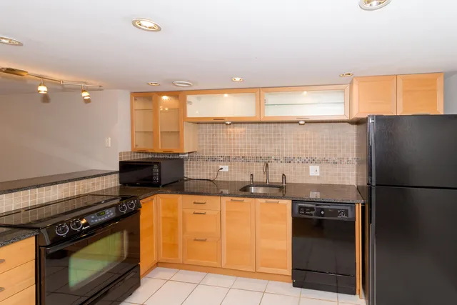 a kitchen with a stove a refrigerator and a sink