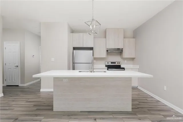 a view of kitchen with granite countertop wooden floor