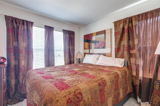 a bedroom with a bed and a night stand