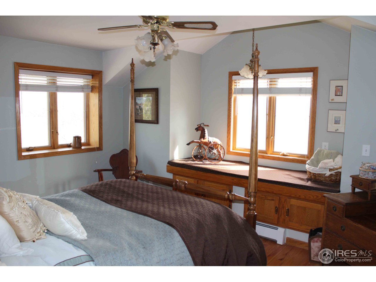 9257 Gunbarrel Ridge Road Boulder, CO 80301 - Photo 13 of 21 a bedroom with a bed and large windows