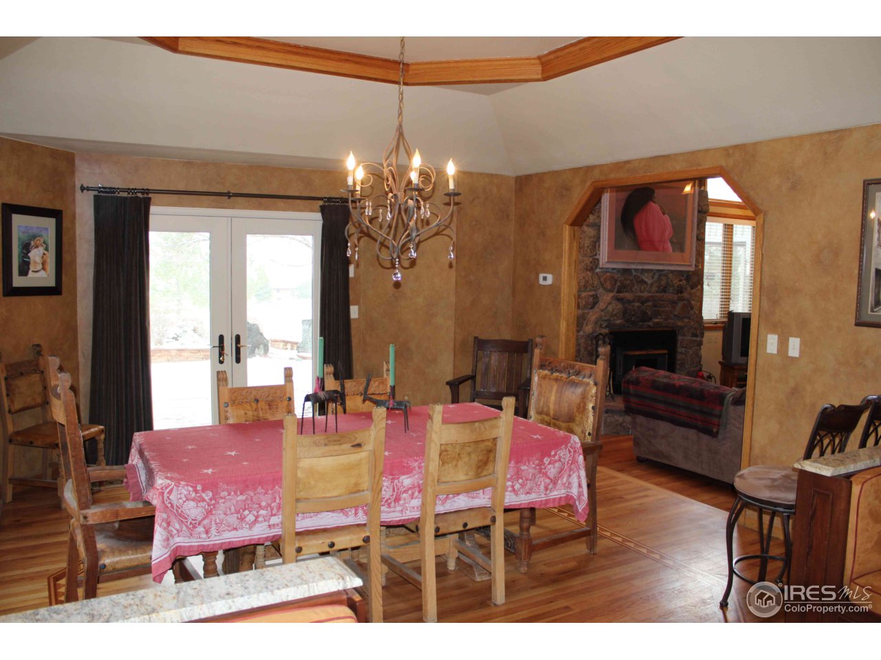 9257 Gunbarrel Ridge Road Boulder, CO 80301 - Photo 7 of 21 a dining room with furniture a chandelier and window