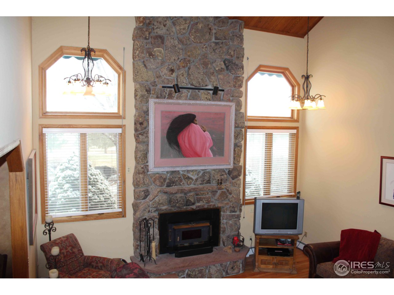 9257 Gunbarrel Ridge Road Boulder, CO 80301 - Photo 8 of 21 a living room with furniture a fireplace and a flat screen tv