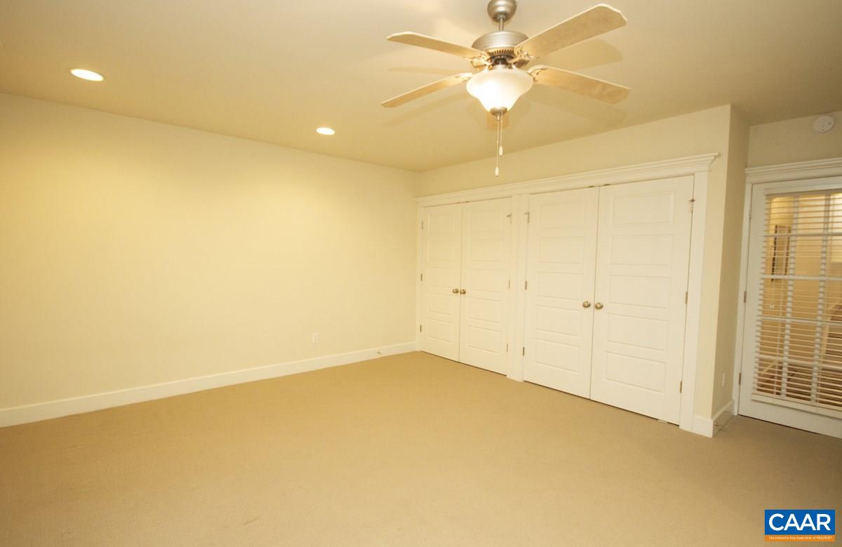2056 Avinity Loop Charlottesville, VA 22902 - Photo 8 of 33 an empty room with a ceiling fan and a window