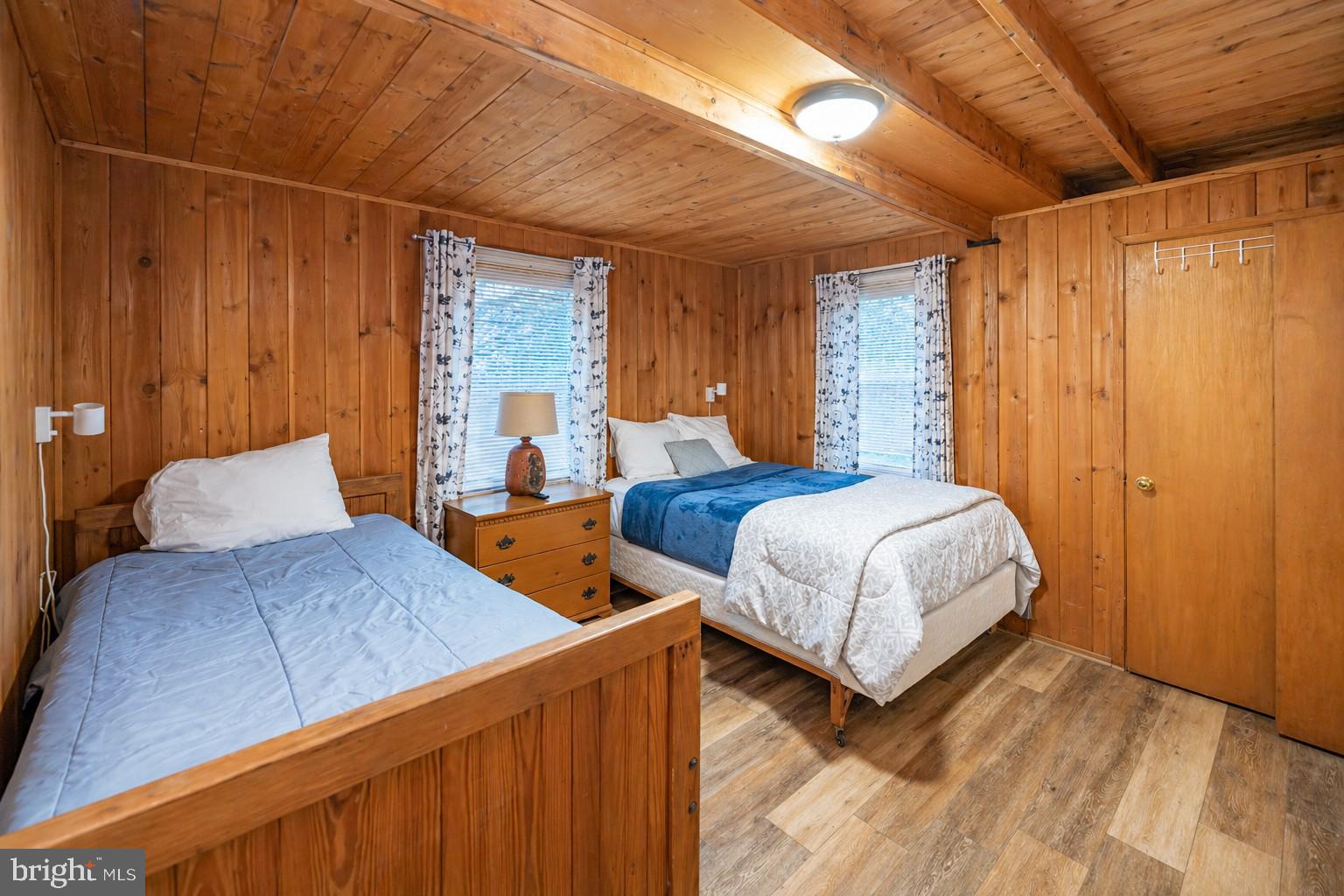 2187 State Park Road Swanton, MD 21561 - Photo 14 of 29 a bedroom with a large bed and a chandelier