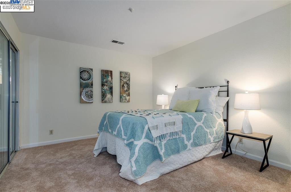 1310 Walden Road, Unit 11 Walnut Creek, CA 94597 - Photo 18 of 26 a bedroom with a bed and chair