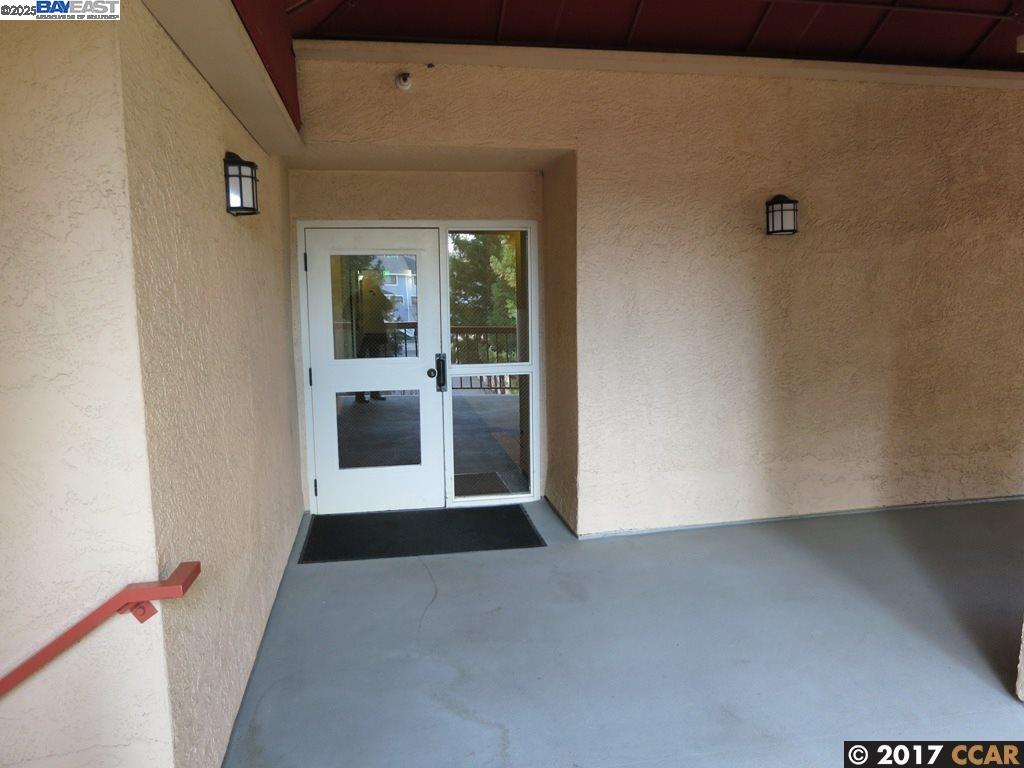 1310 Walden Road, Unit 11 Walnut Creek, CA 94597 - Photo 23 of 26 a view of a hallway with wooden floor and a large window